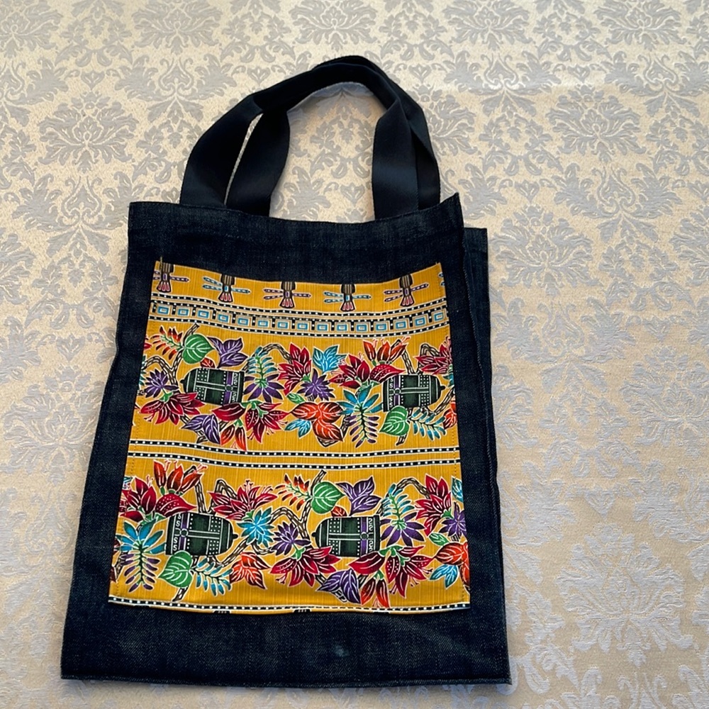 Black denim tote bag with colorful front pocket